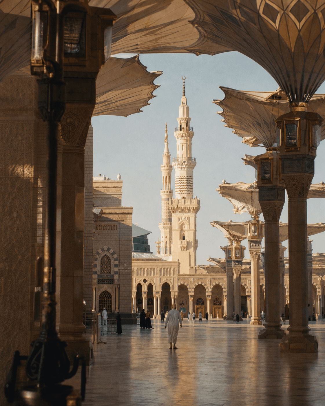 A quiet sunlit colonnade at the Prophet's Mosque in Madinah